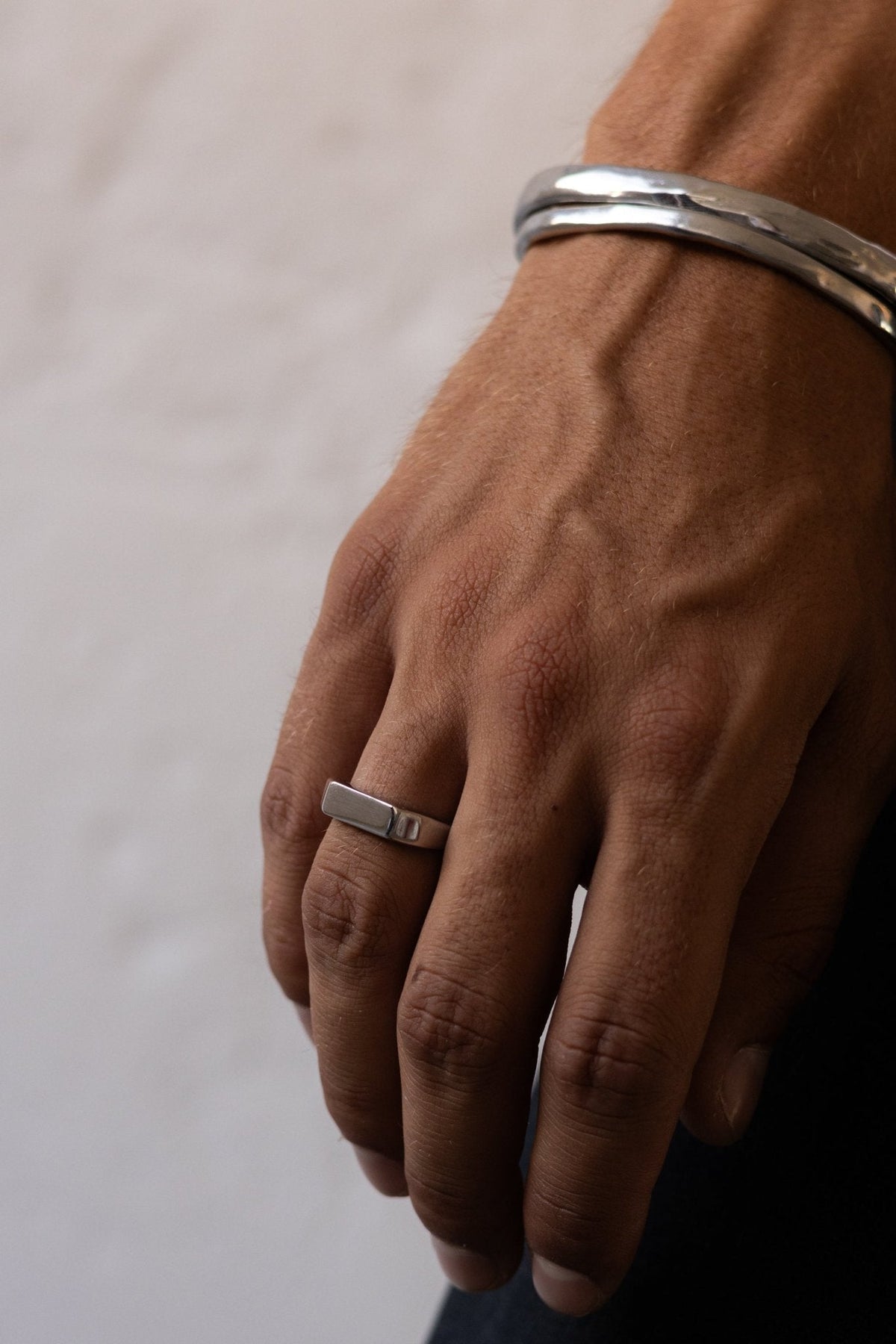 Close-up of the signet ring on the finger
