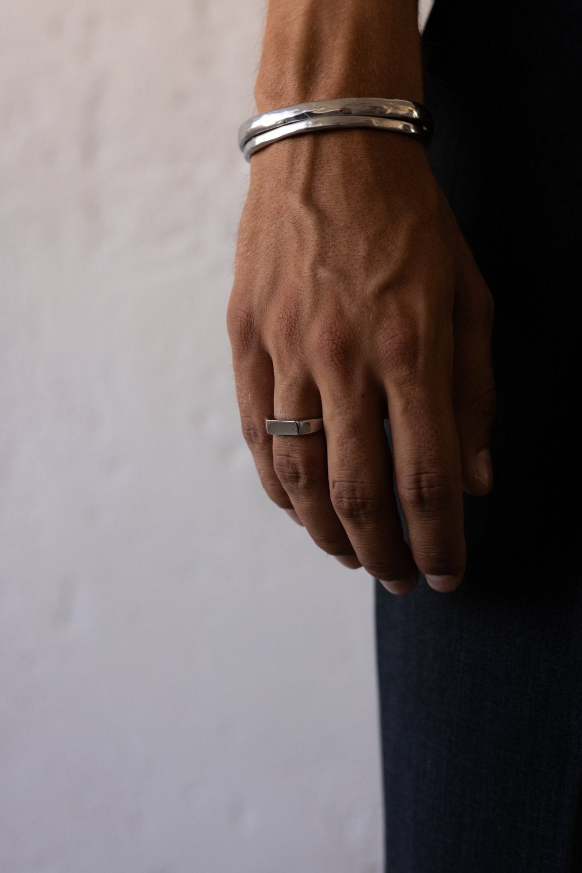 Hand at rest wearing the slim signet ring
