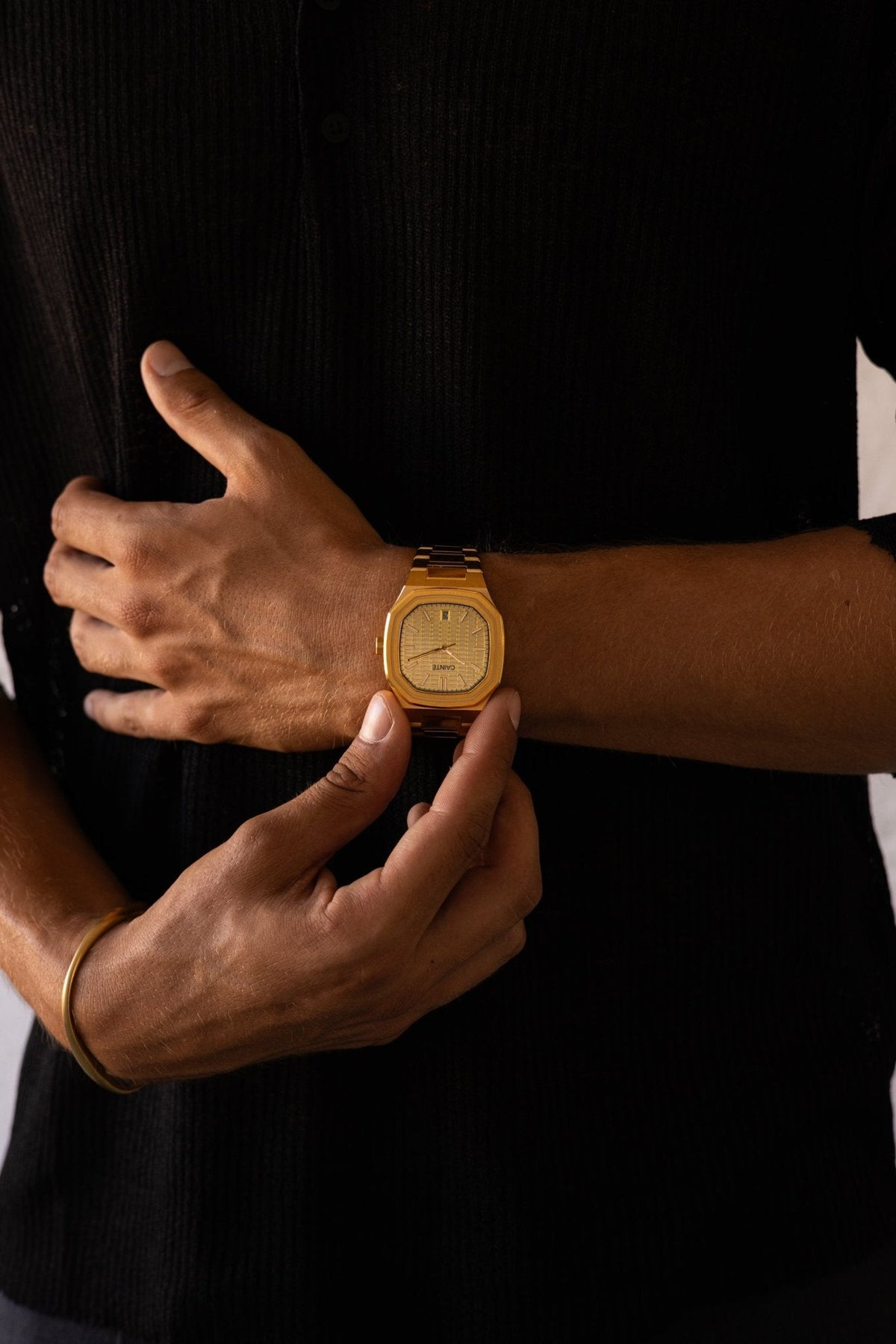 Hand over a black shirt with the watch on the wrist