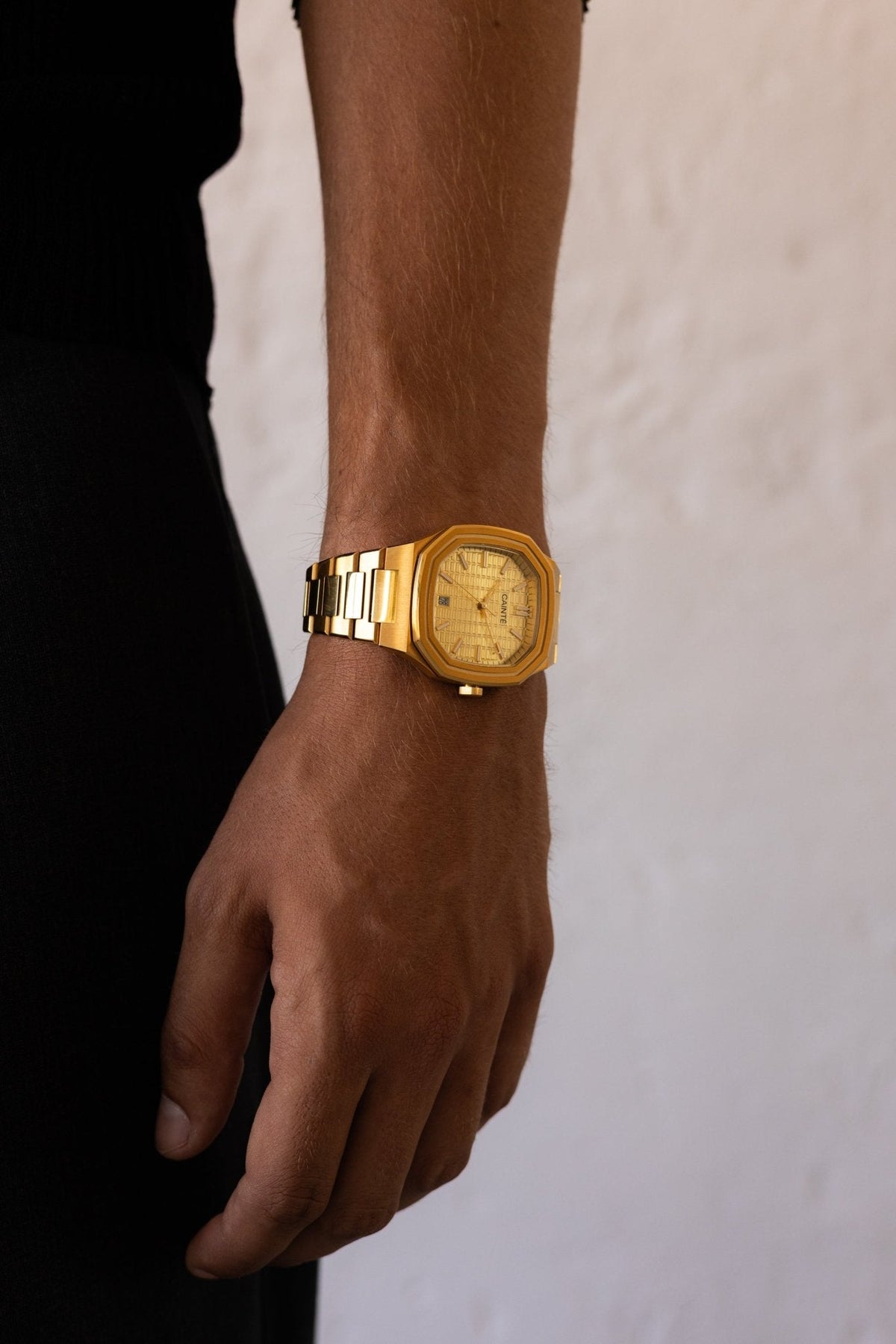 Arm hanging by the side wearing the watch