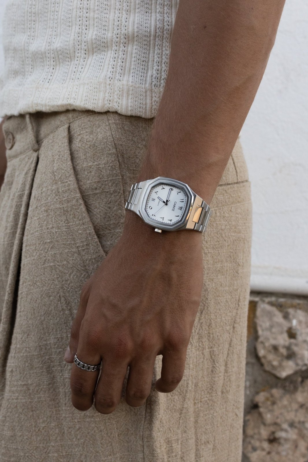 Wrist by linen trousers wearing the watch