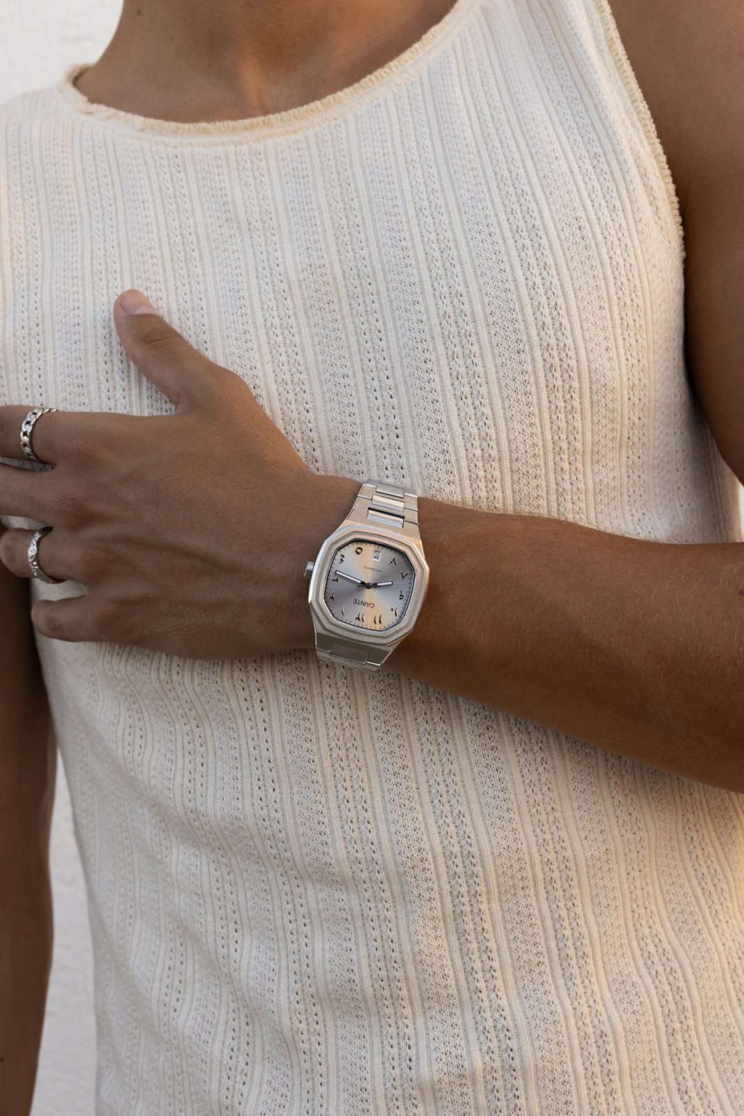 Hand on the chest with the watch on the wrist