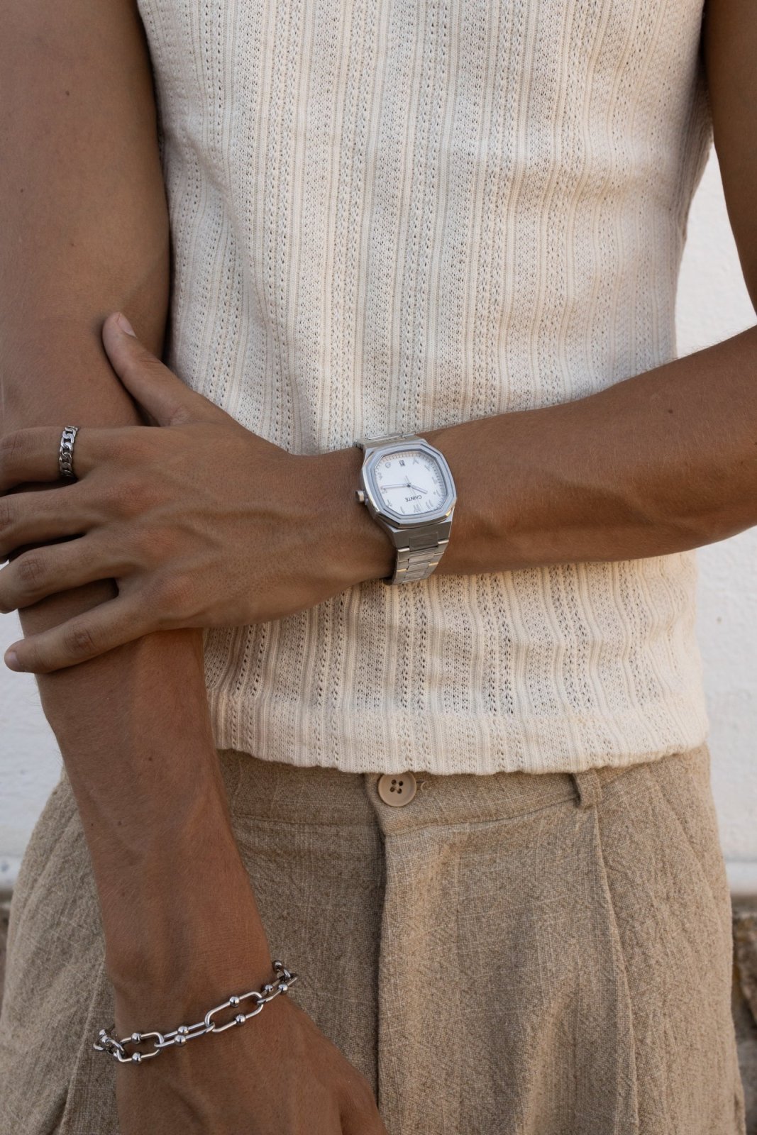 Arm across the body wearing the watch over a knit tank
