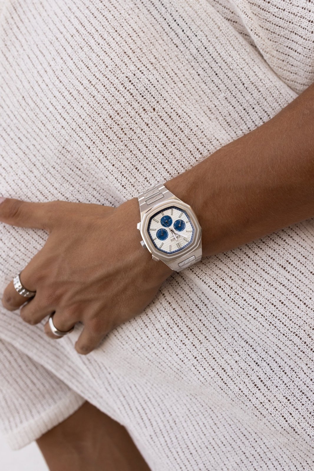 Watch on a wrist against a knit sweater