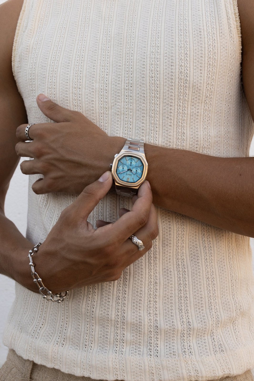 Close view of hands adjusting the watch on a ribbed top