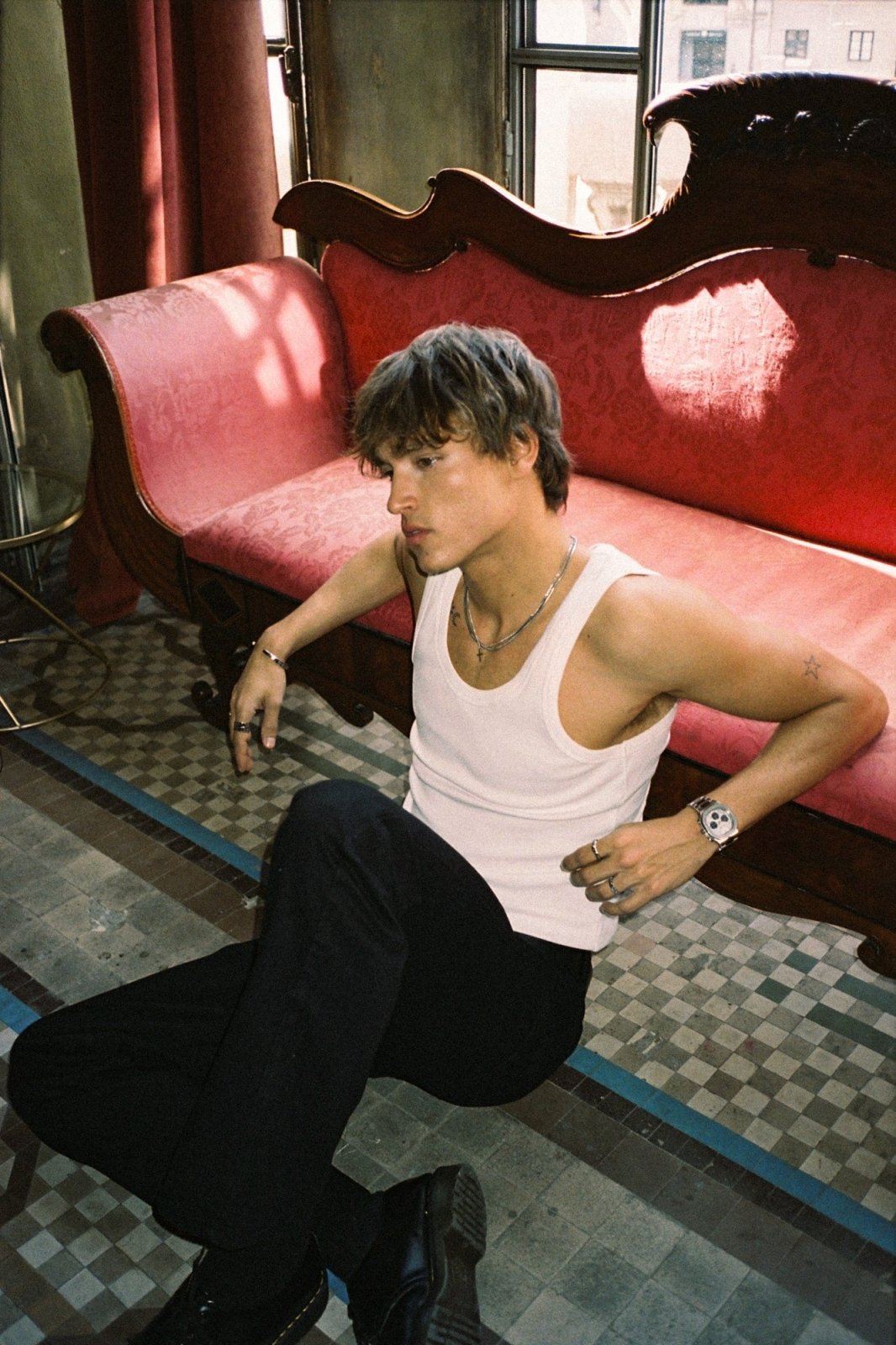 Man on a red sofa wearing the watch