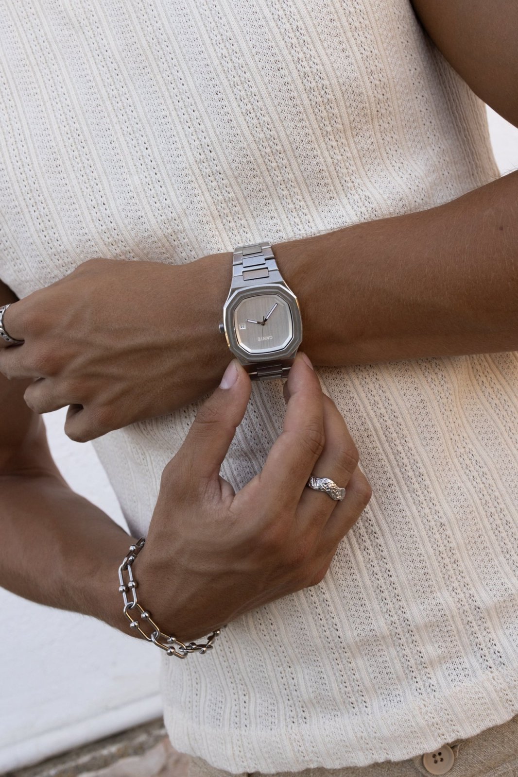 Close view of hands adjusting the watch on a ribbed top