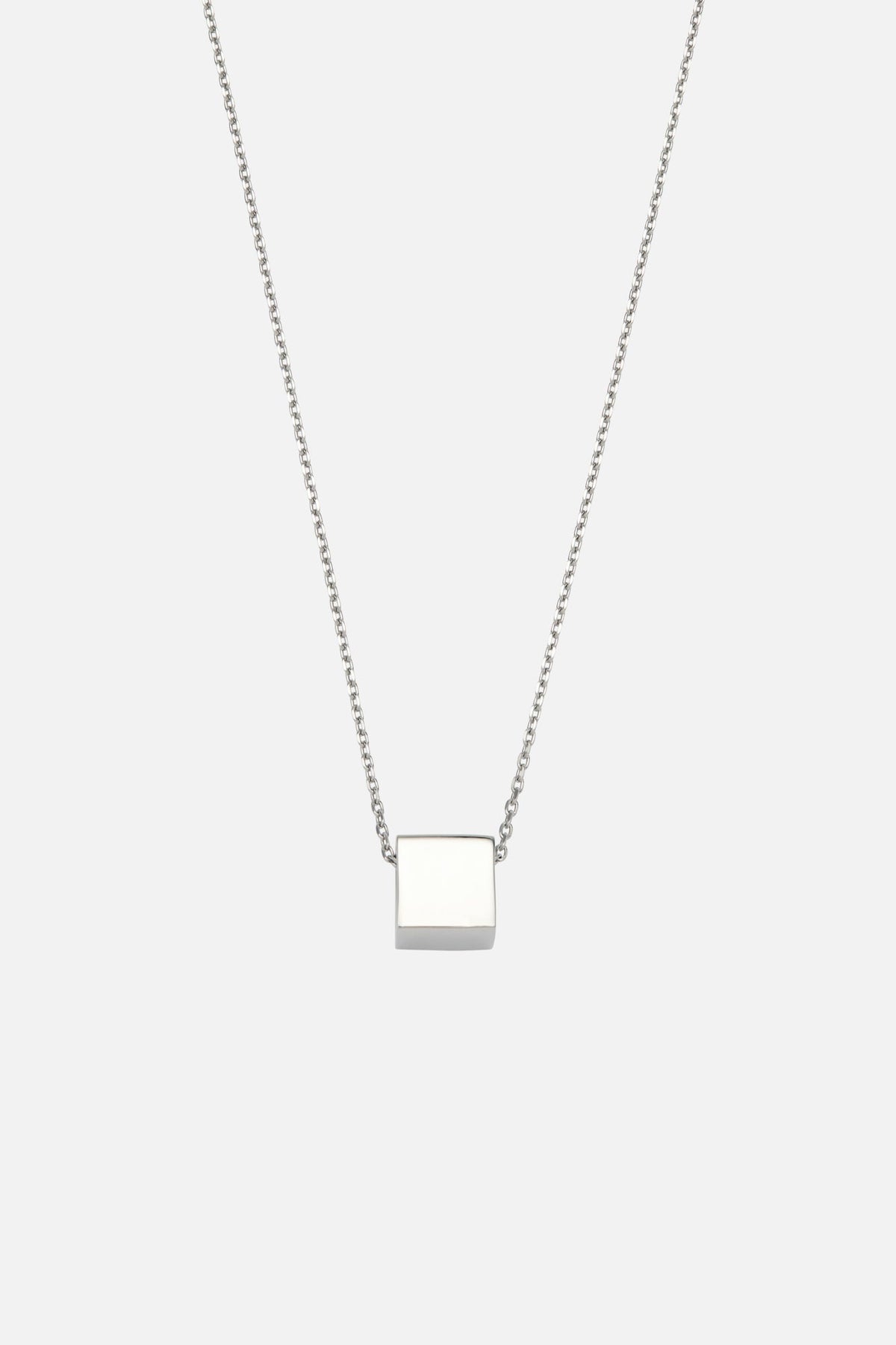 Silver-tone cube pendant necklace, front view on a light background