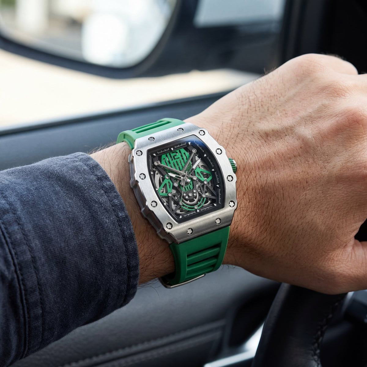 Green skeleton watch on the wrist in a car