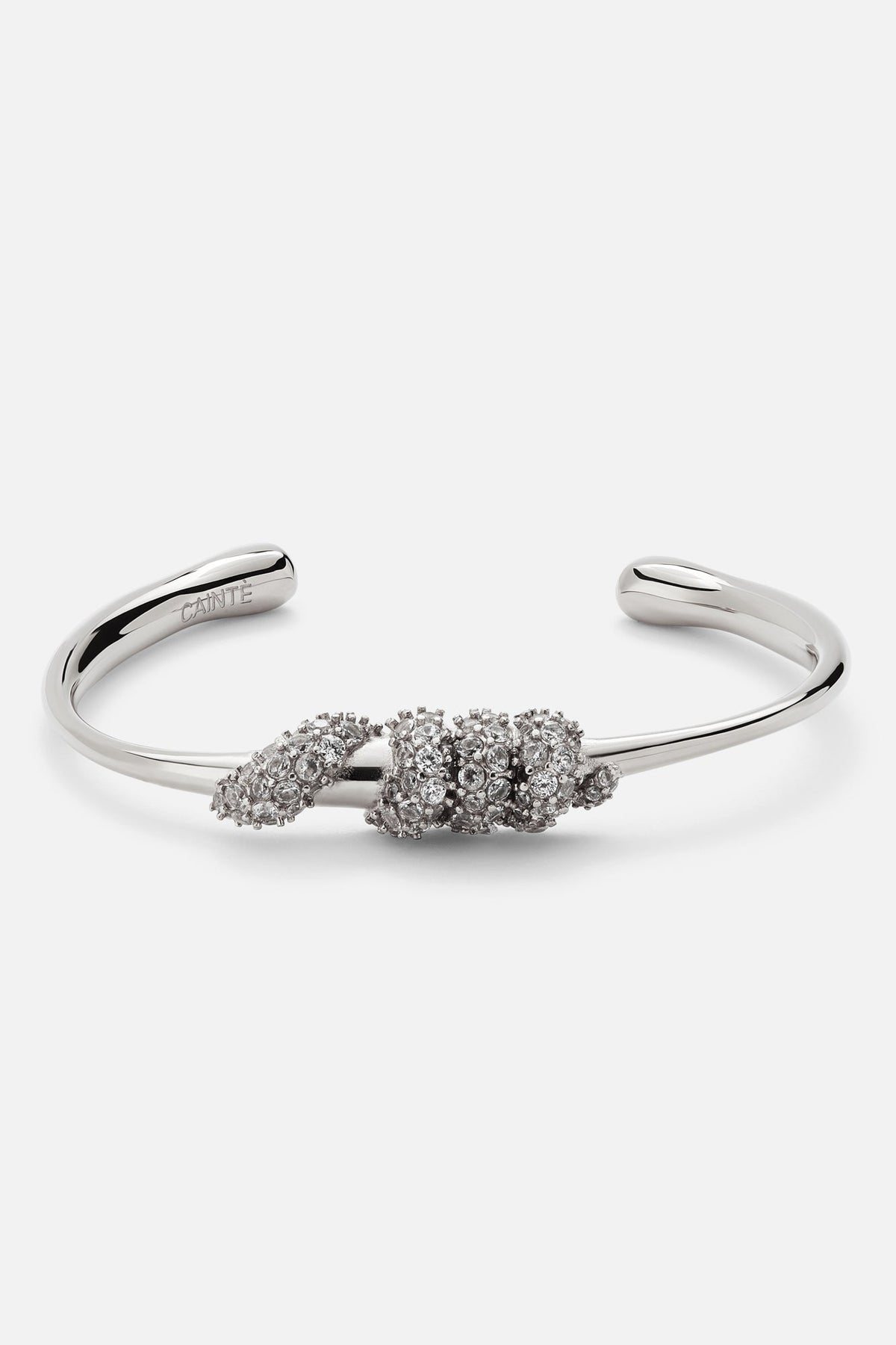 Silver-tone stone-set knot cuff bracelet, front view on a light background