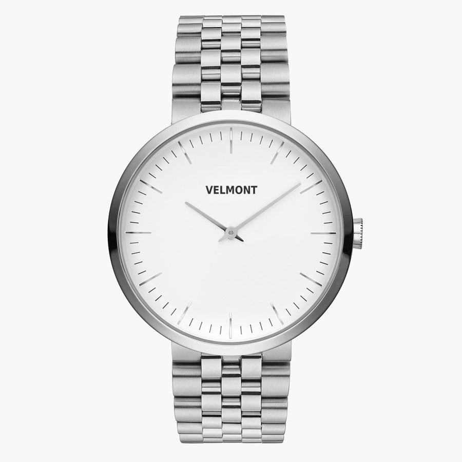 Minimalist watch with a white dial and silver-tone case on a matching link bracelet.