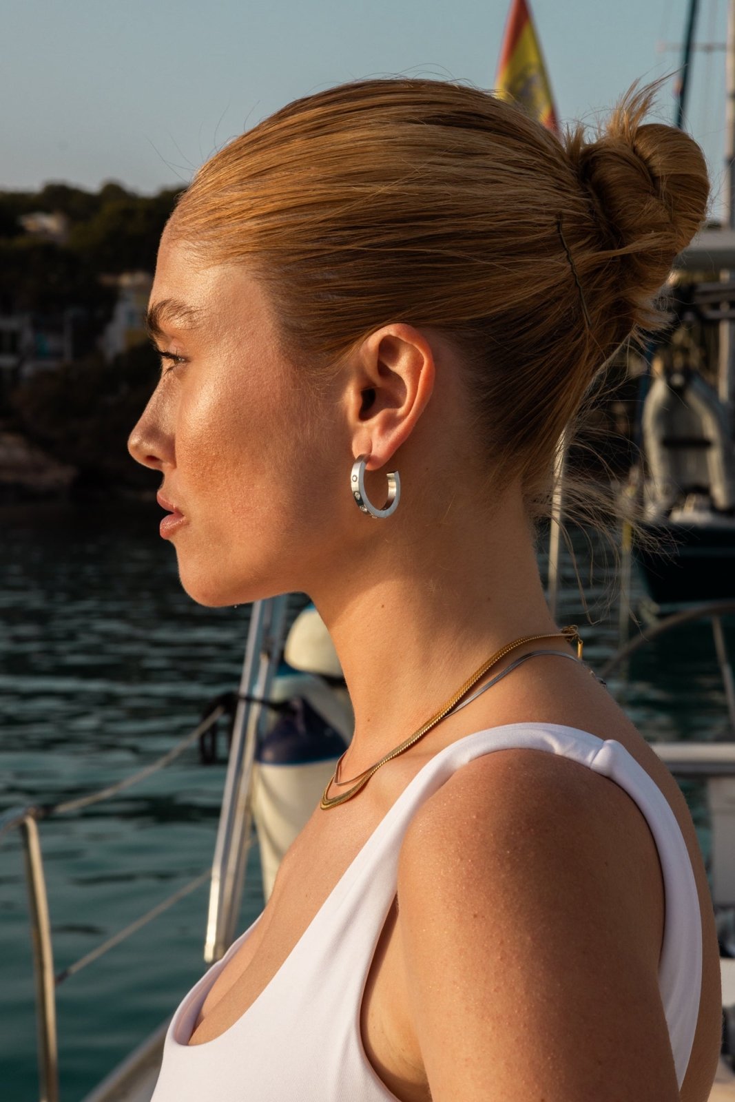 Model wearing the hoop earring, profile view