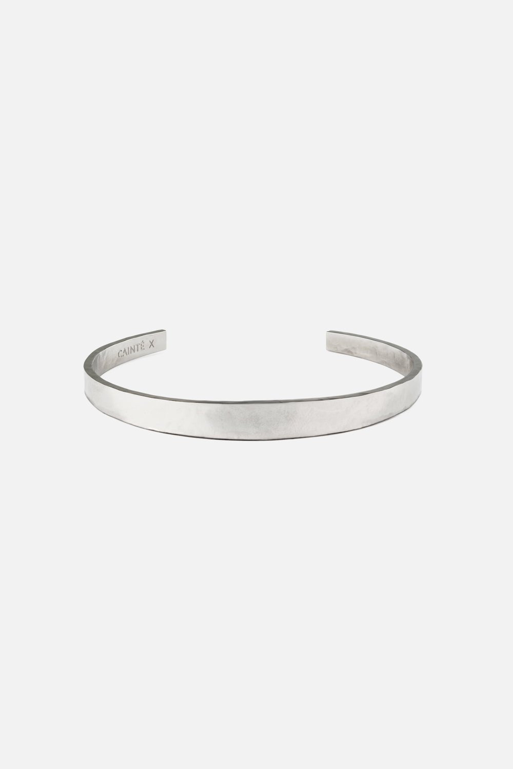 Silver-tone narrow flat cuff bracelet, front view on a light background