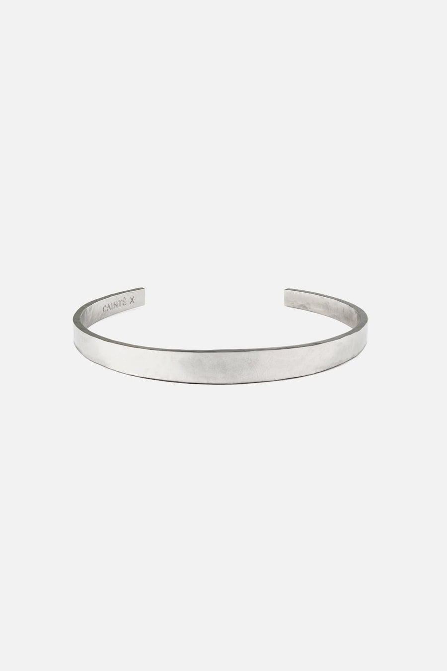 Silver-tone narrow flat cuff bracelet, front view on a light background