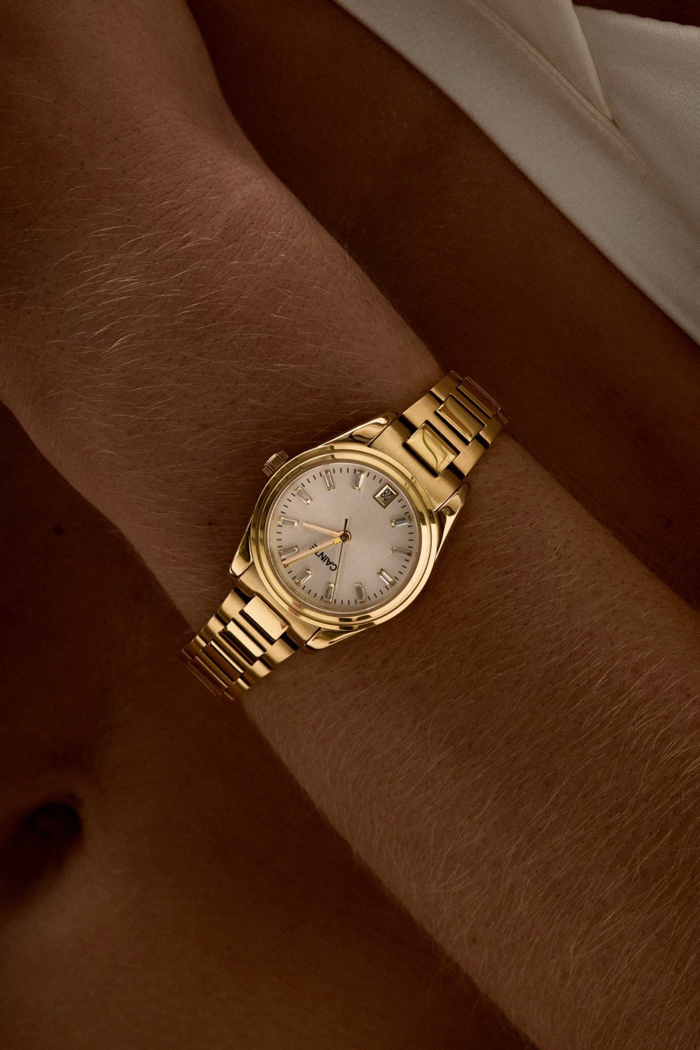 Close-up of the small round watch on a woman’s wrist