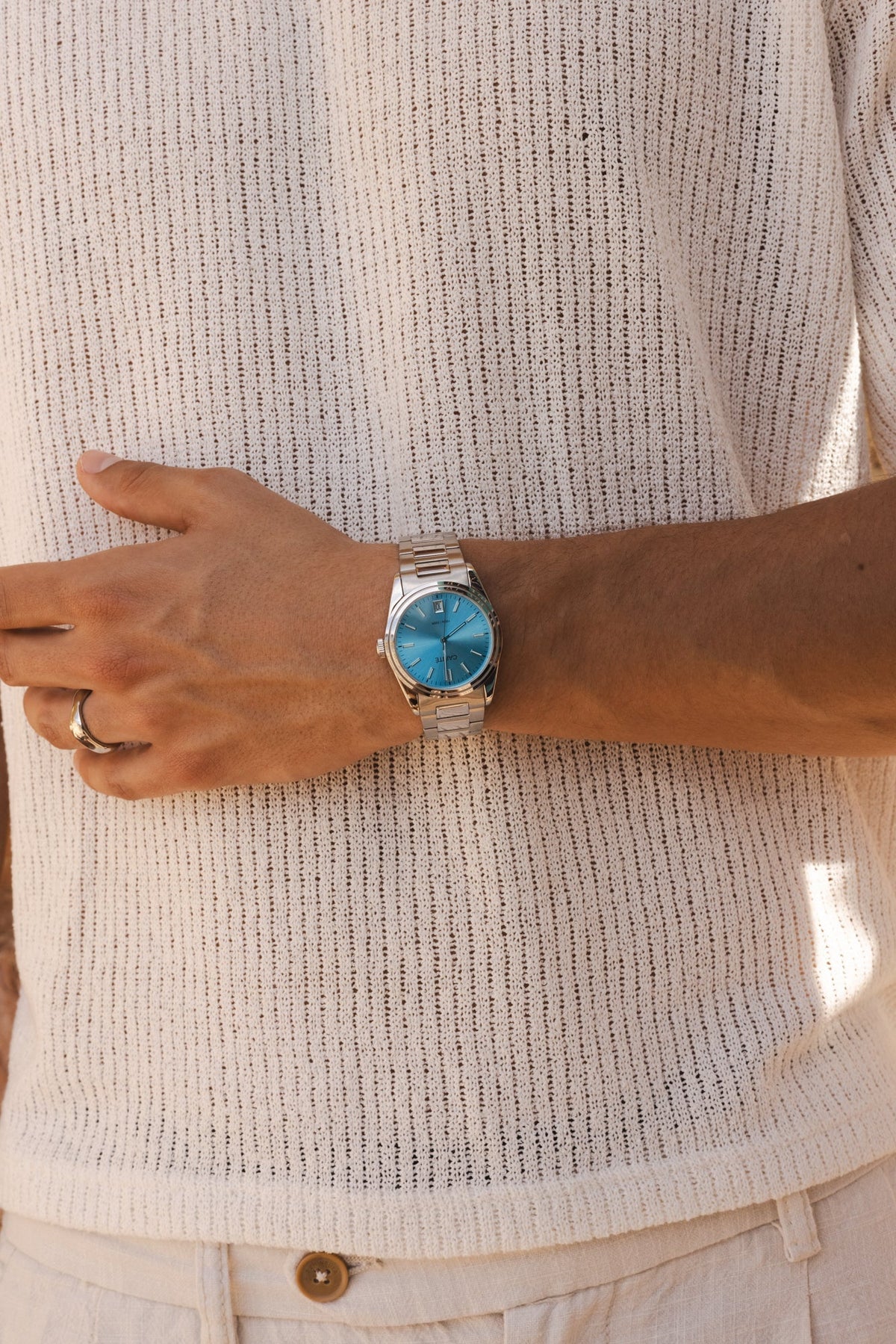 Arm across a knit sweater wearing the watch