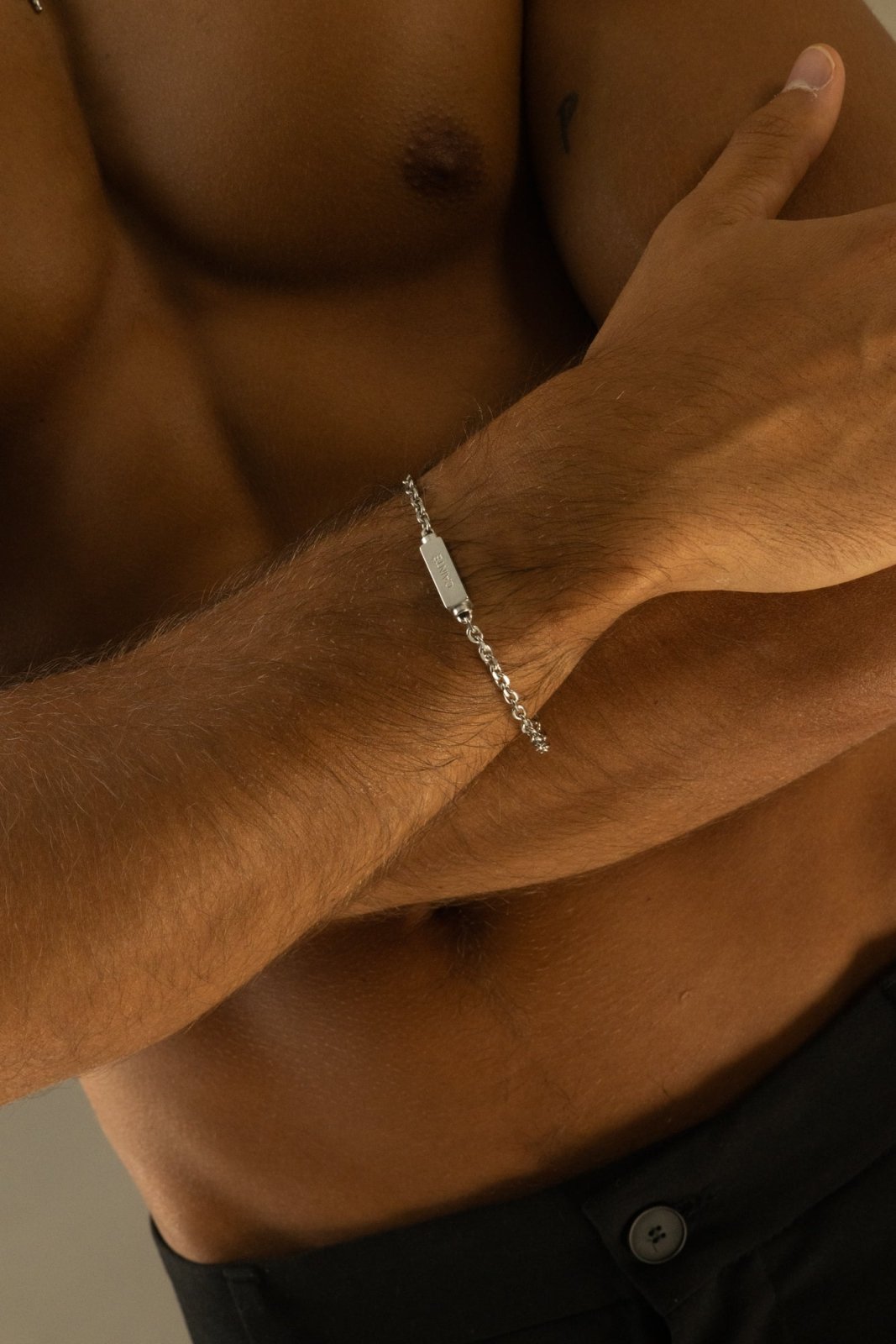 Silver-tone chain bracelet on the wrist, close view
