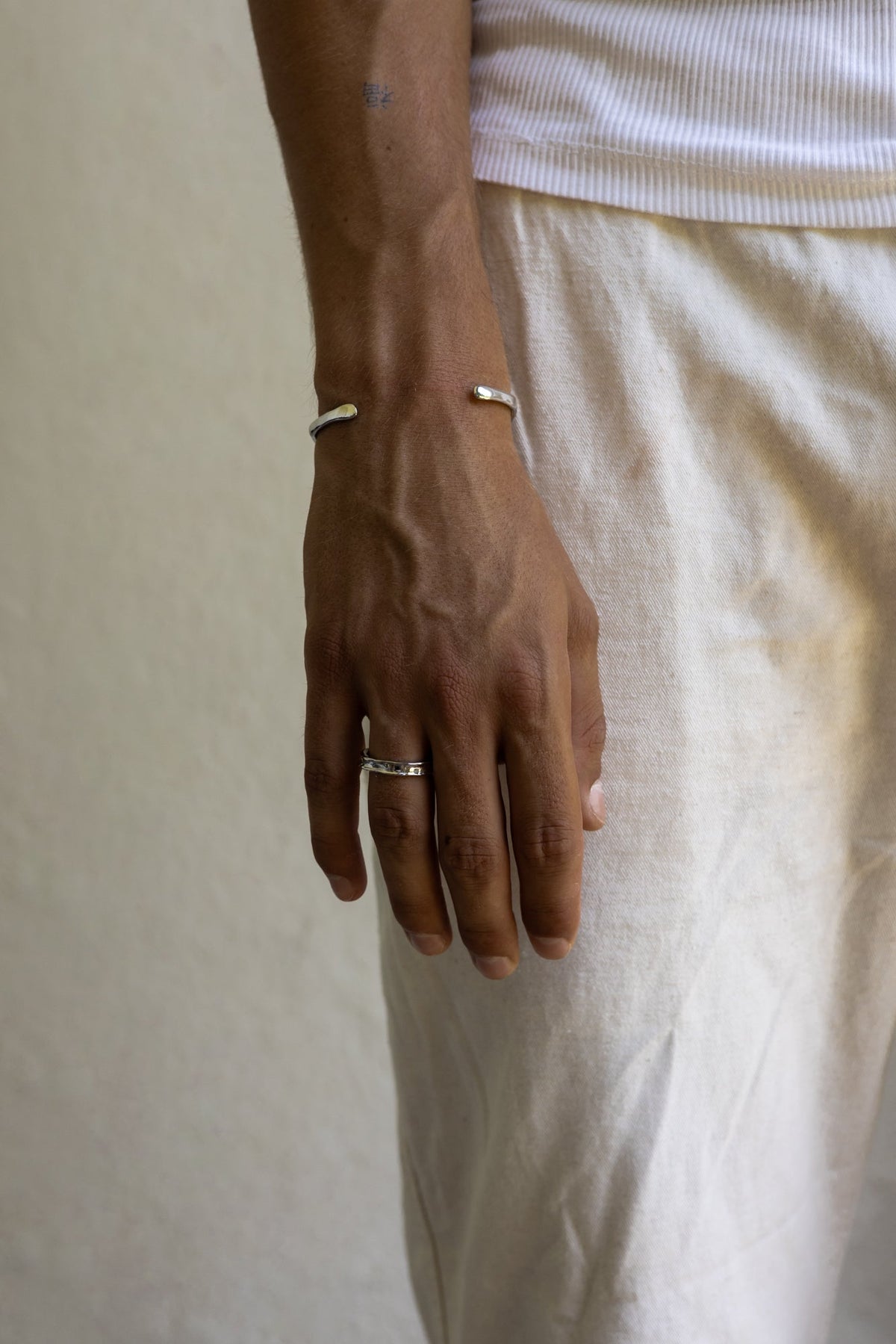 Hand at rest wearing the textured band ring