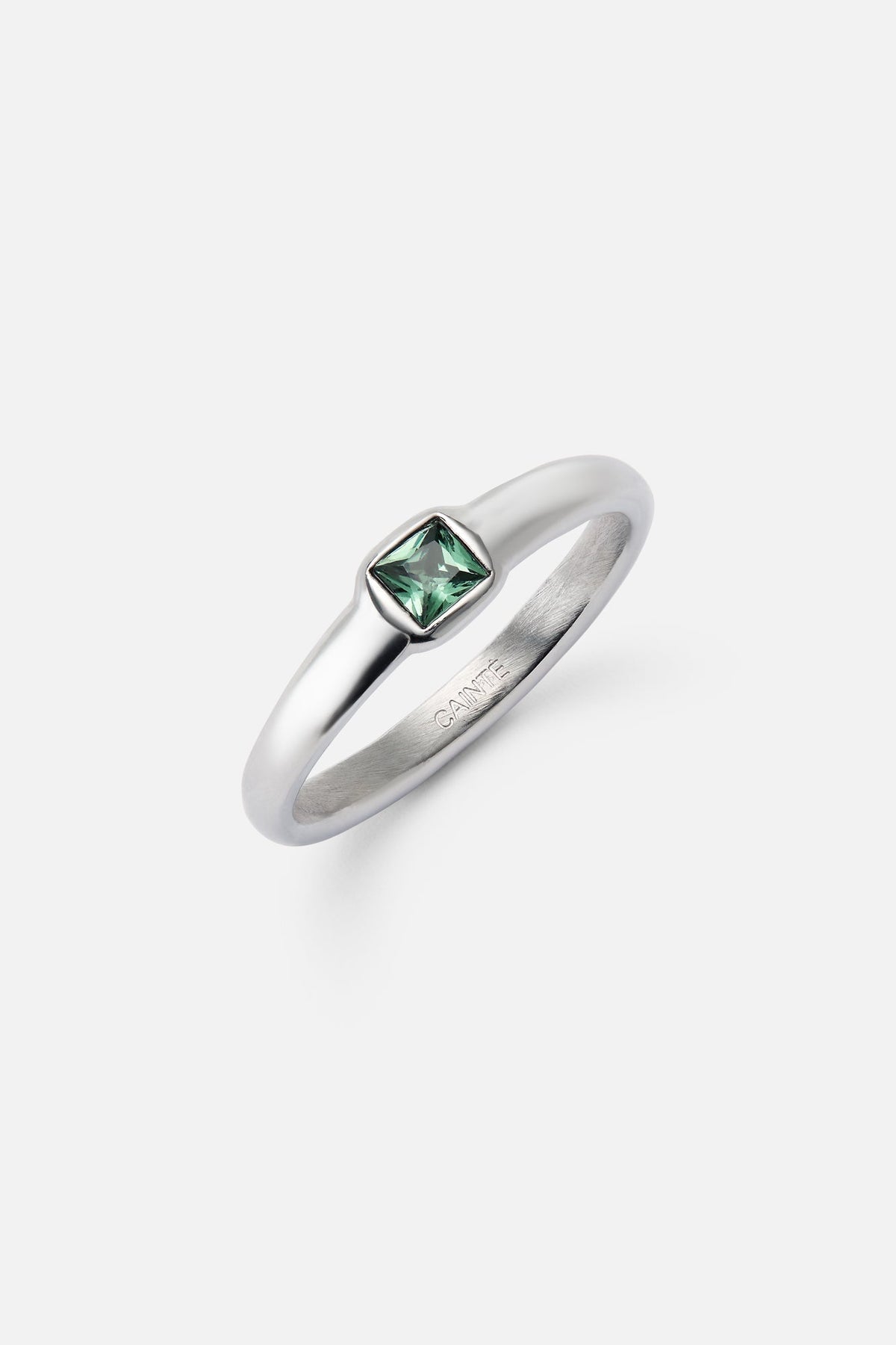 Green stone ring at an angle showing the bezel