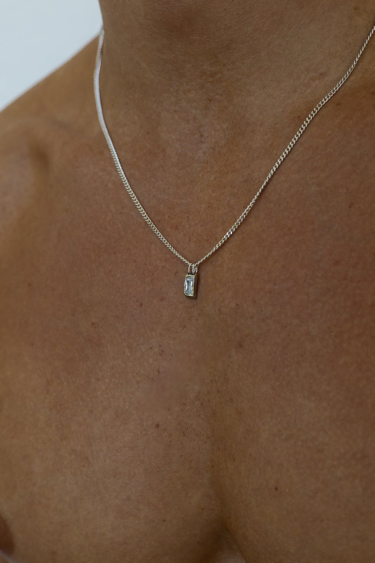 Silver-tone necklace with a small white inlay tag, view 7 of 7