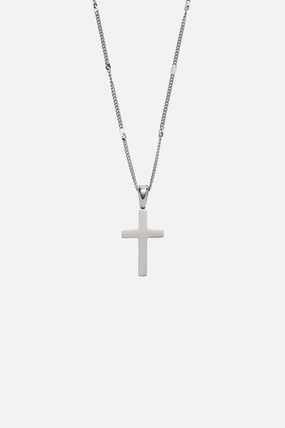 Silver-tone cross pendant on a fine chain, close-up
