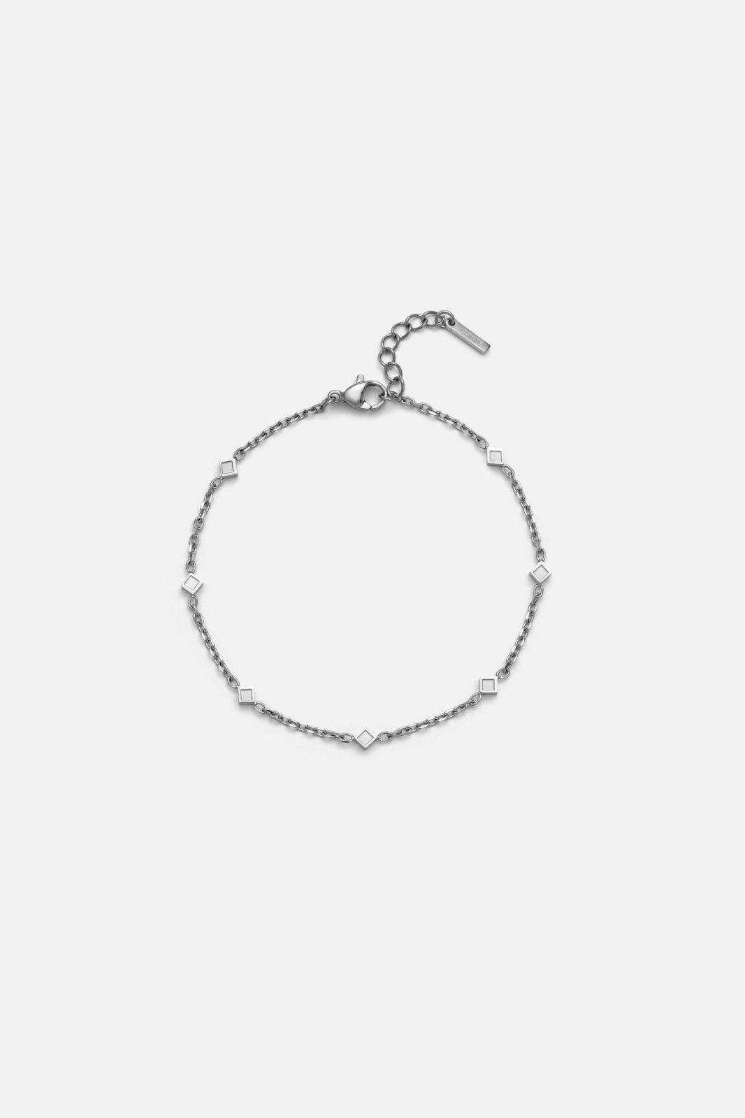 Silver-tone station chain bracelet with beads, front view on a light background