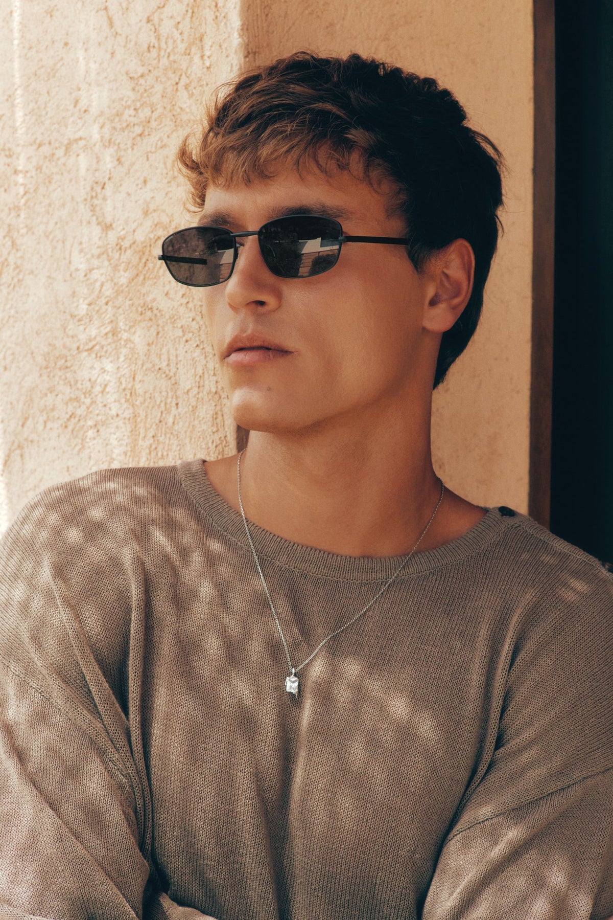 Man wearing the thin black sunglasses