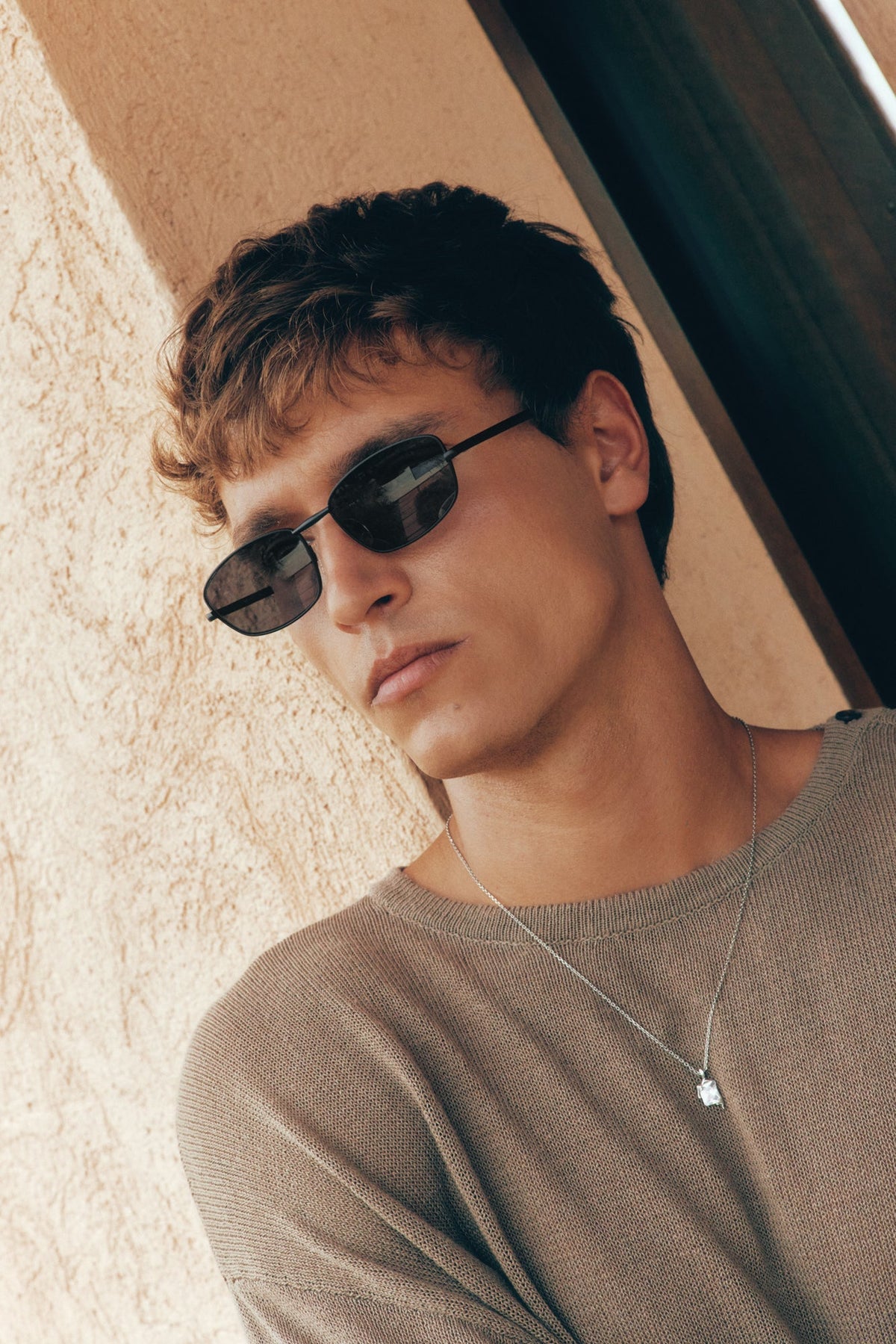 Man tilting his head wearing the sunglasses