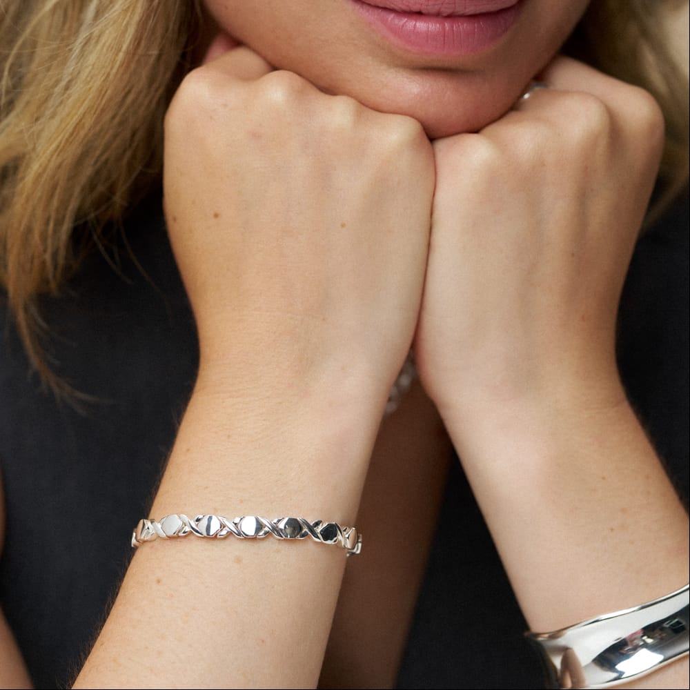 X and hexagon link bracelet worn with a bangle