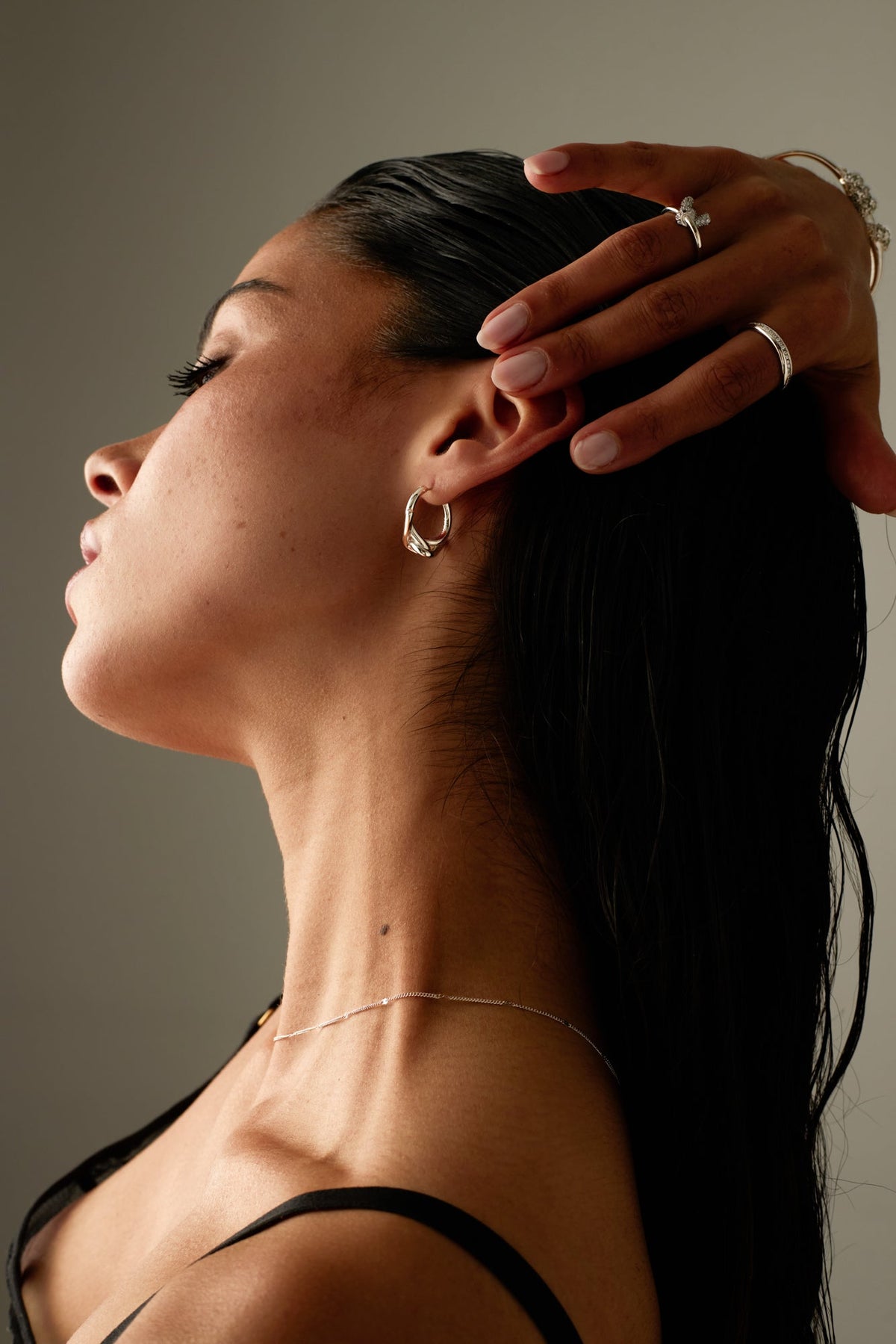 Model with her hand in her hair wearing the hoop