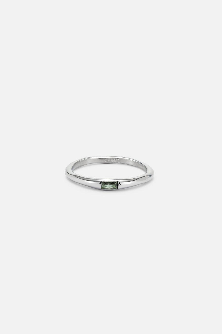 Thin band ring with a tiny green stone, front view