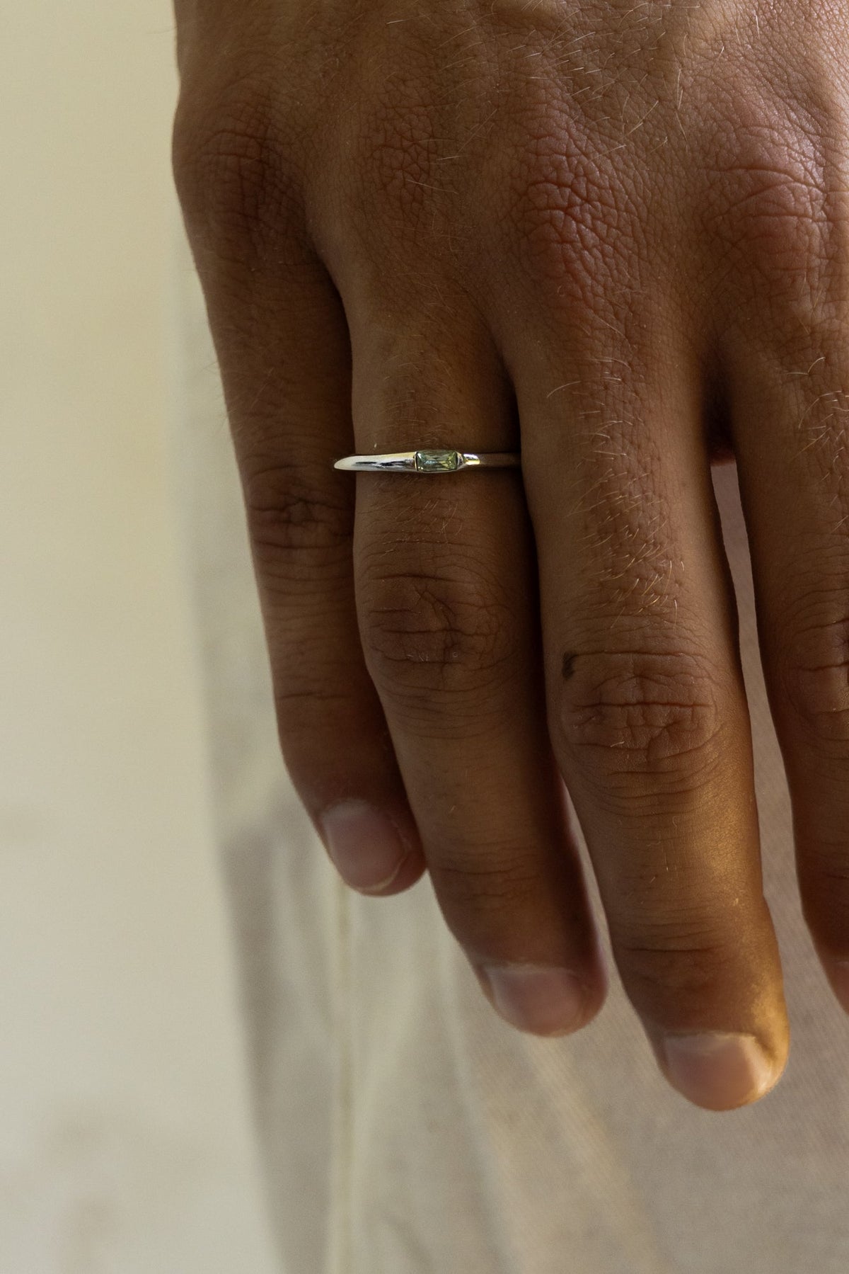 Close-up of the thin ring on the finger