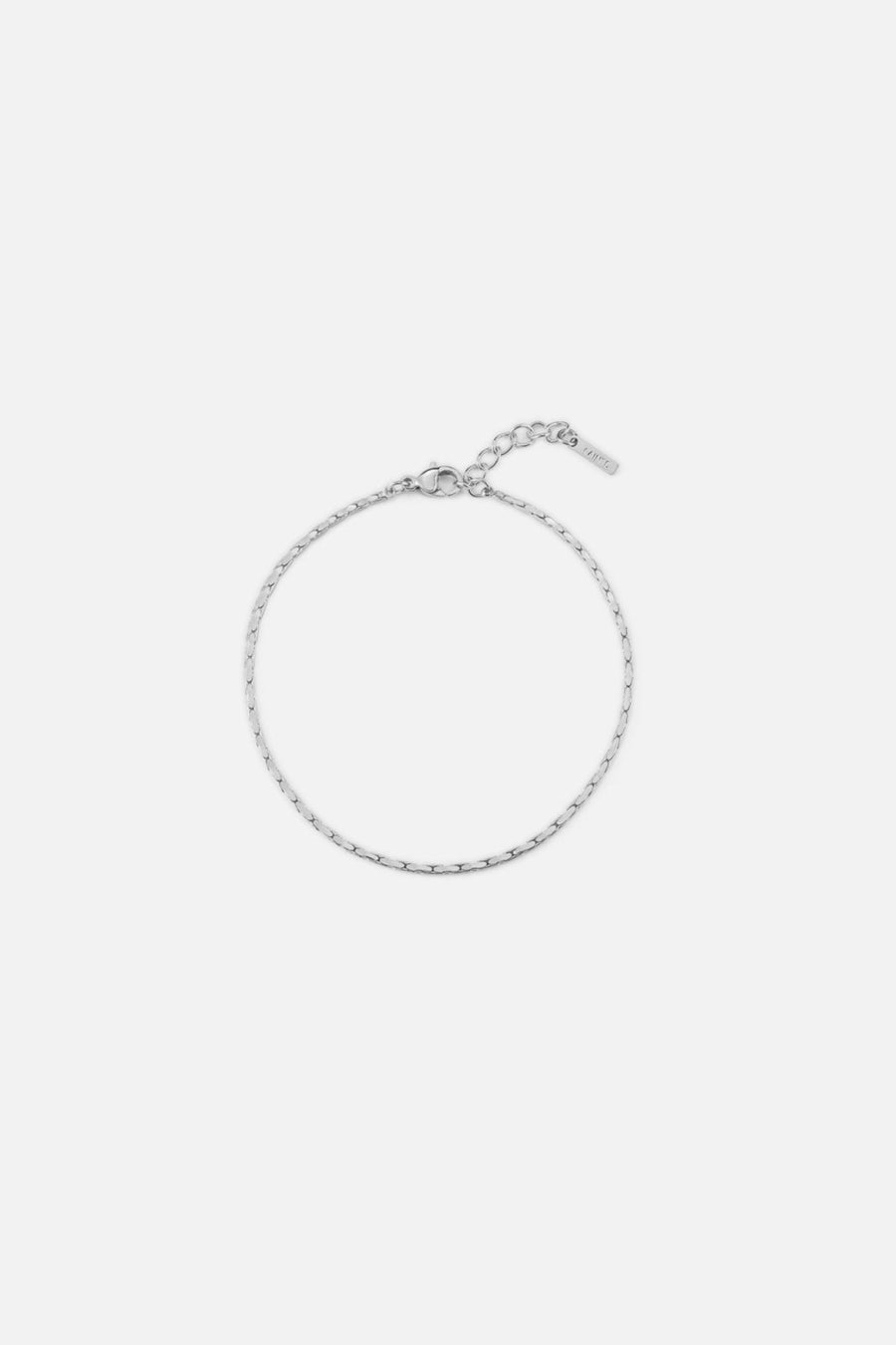 Silver-tone fine textured chain bracelet, front view on a light background