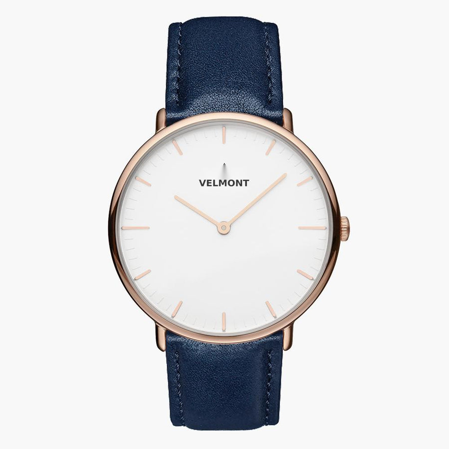 White-dial watch with a rose gold-tone case on a smooth navy strap.