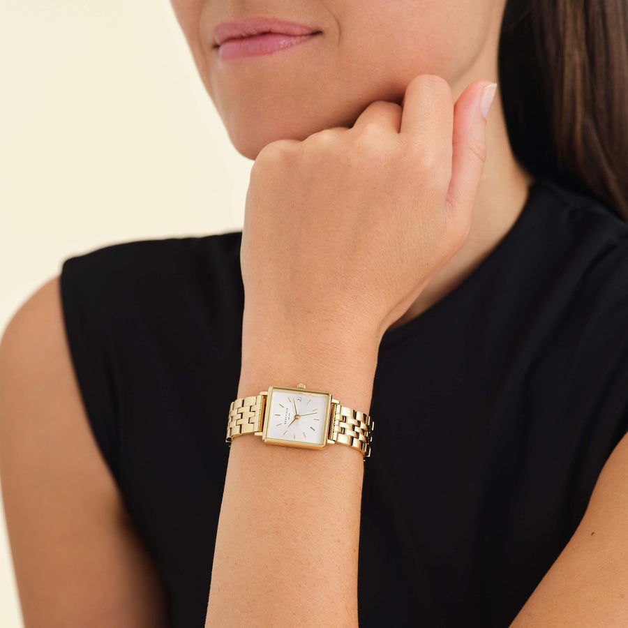 Square watch worn with a black top