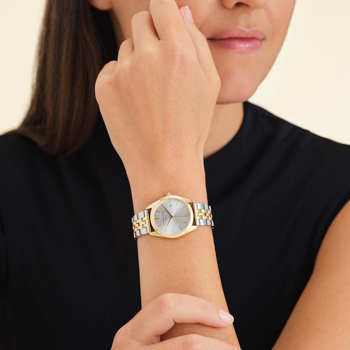 Two-tone watch worn near the face