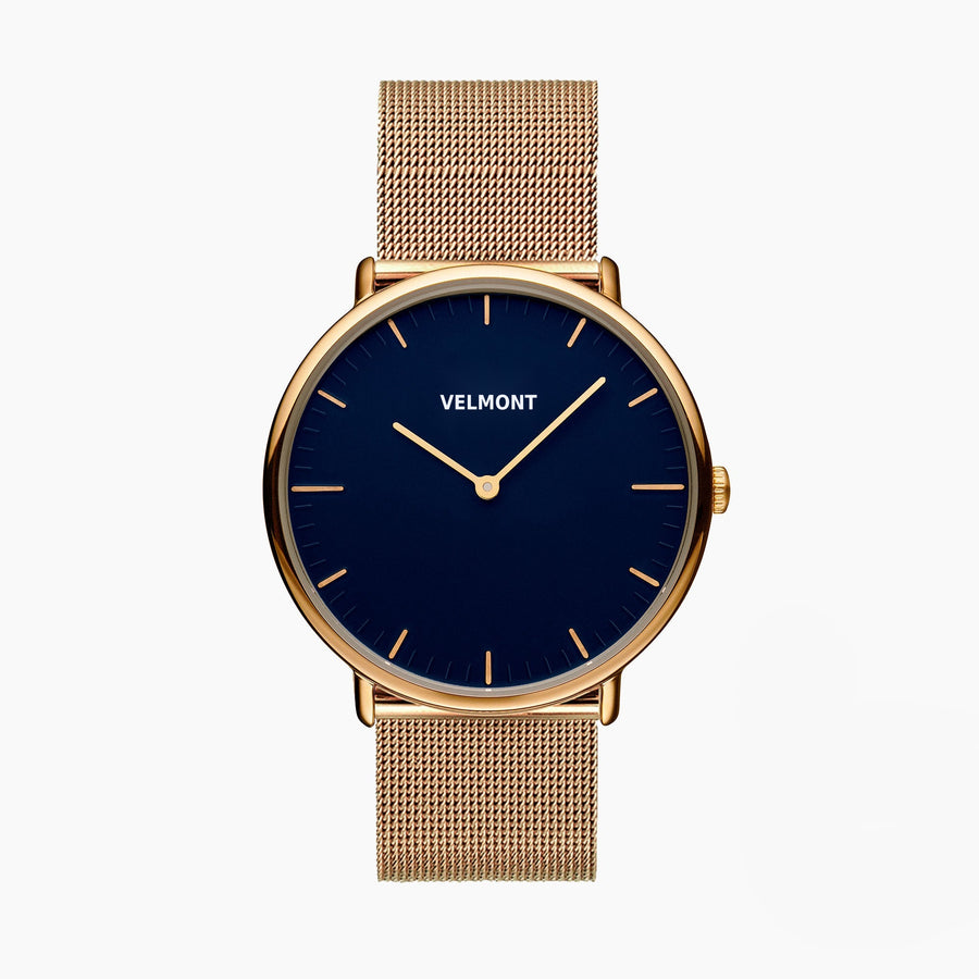 Watch with a navy blue dial and gold-tone case on a gold-tone mesh strap.