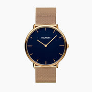 Watch with a blue sunburst dial and gold-tone case on a gold-tone mesh strap, shown from the front.