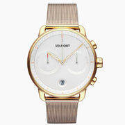 Chronograph-style watch with a white dial and gold-tone case on a fine mesh strap.