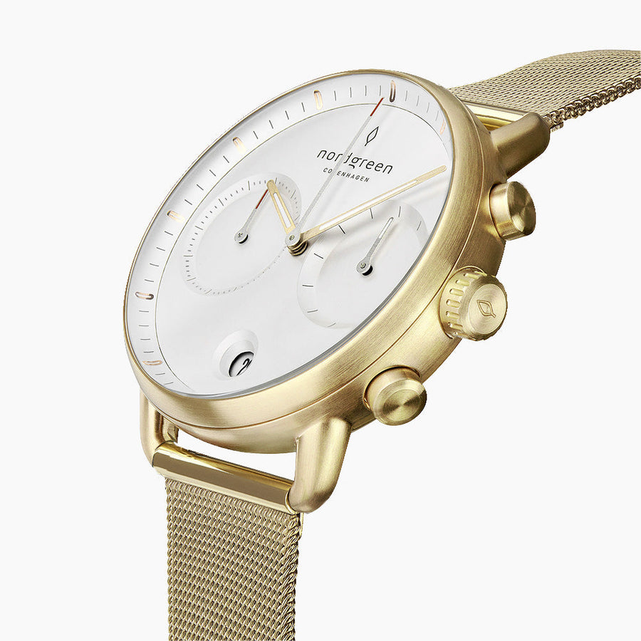 Angled view of the gold-tone pushers and crown beside the white two-subdial face.