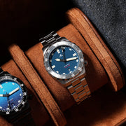 Blue-dial sports watch displayed in a brown watch box