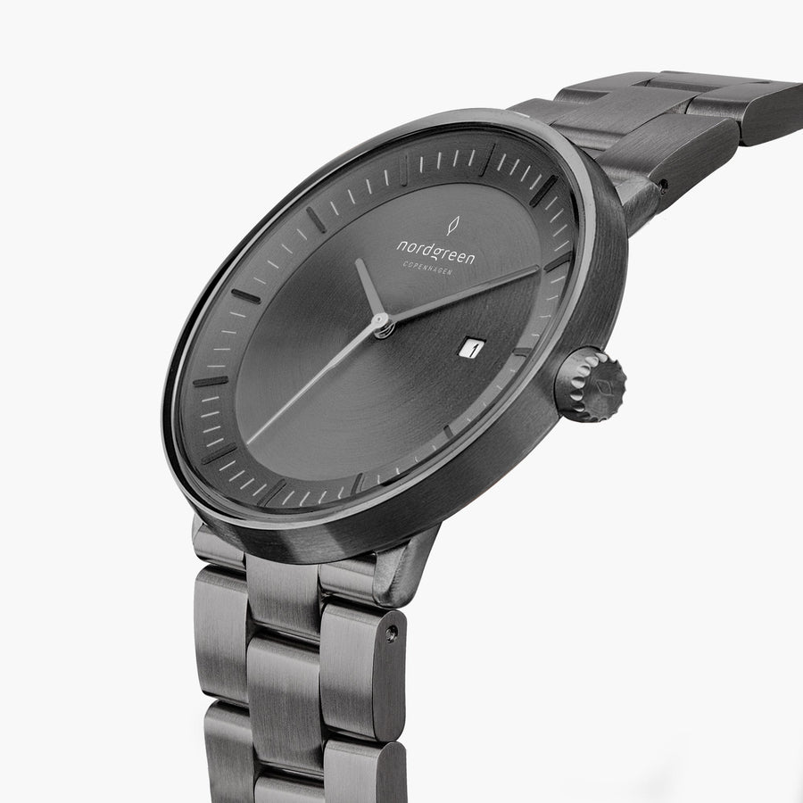 Angled view of the gray dial, date window and fluted gunmetal crown.