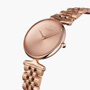 Angled look at the minimalist rose gold dial and sculpted lugs.