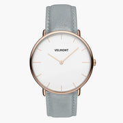 Watch with a white dial and rose gold-tone case on a dove gray strap, shown from the front.