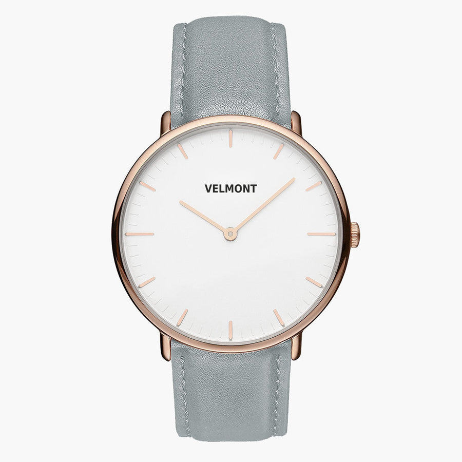 Watch with a white dial and rose gold-tone case on a dove gray strap, shown from the front.