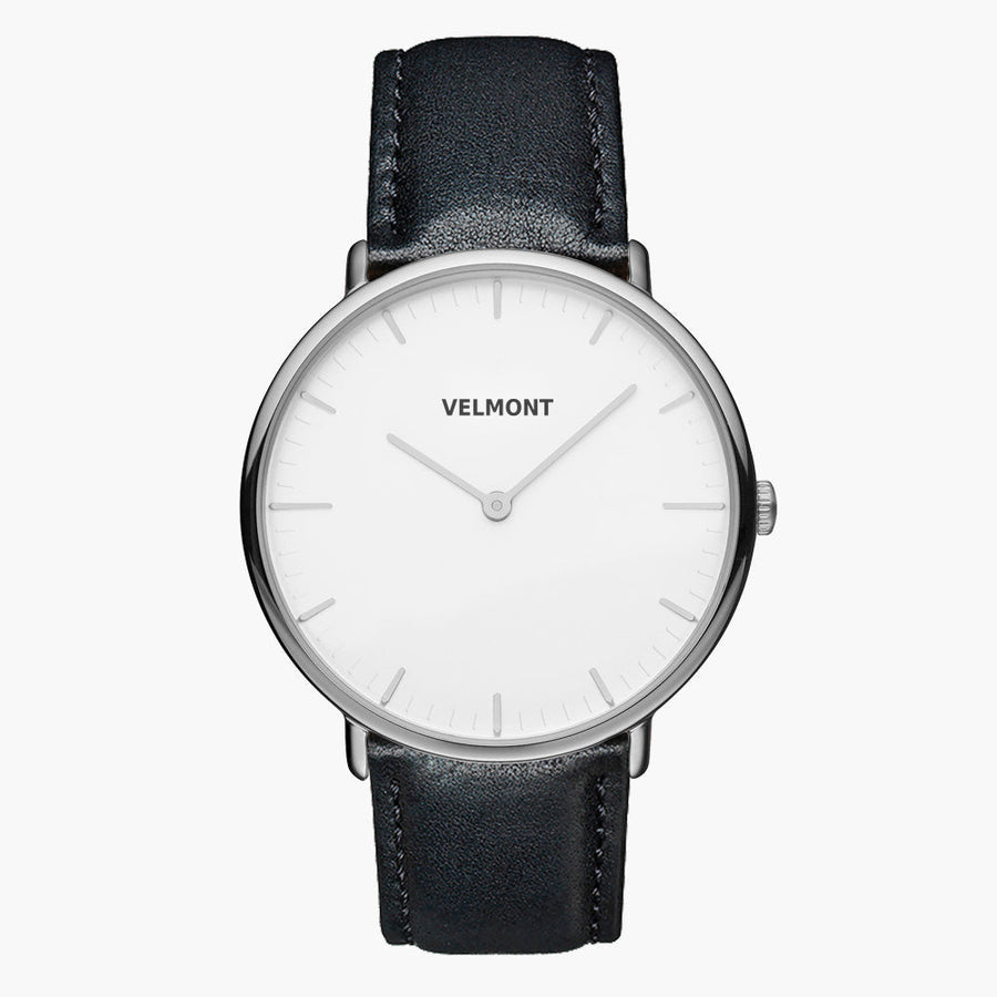 Minimal watch with a white dial and silver-tone case on a black strap, front view.
