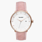 Watch with a white dial and rose gold-tone case on a dusty pink strap.