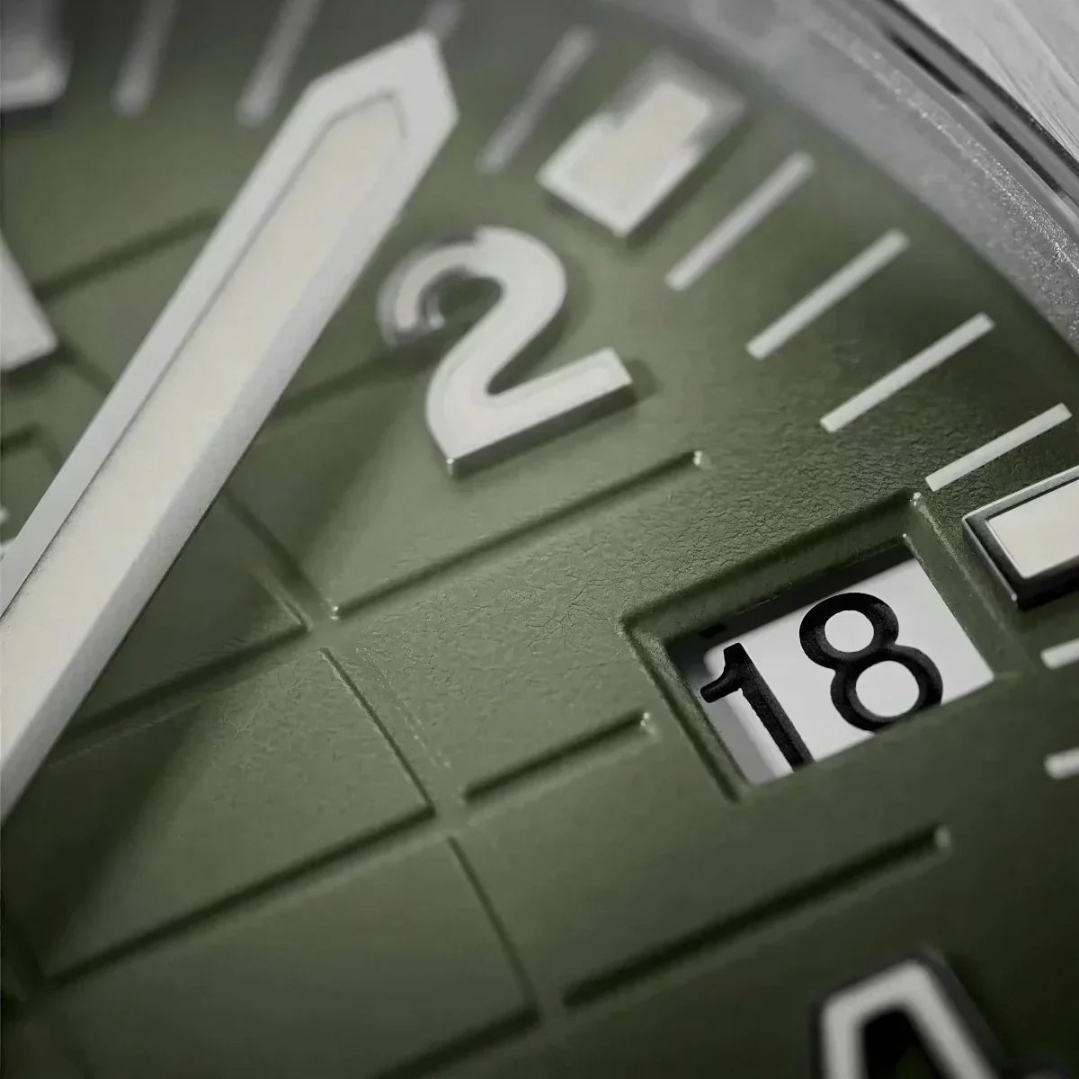 Close-up of the green grid dial and date window