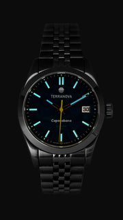 Blue dial watch glowing in low light