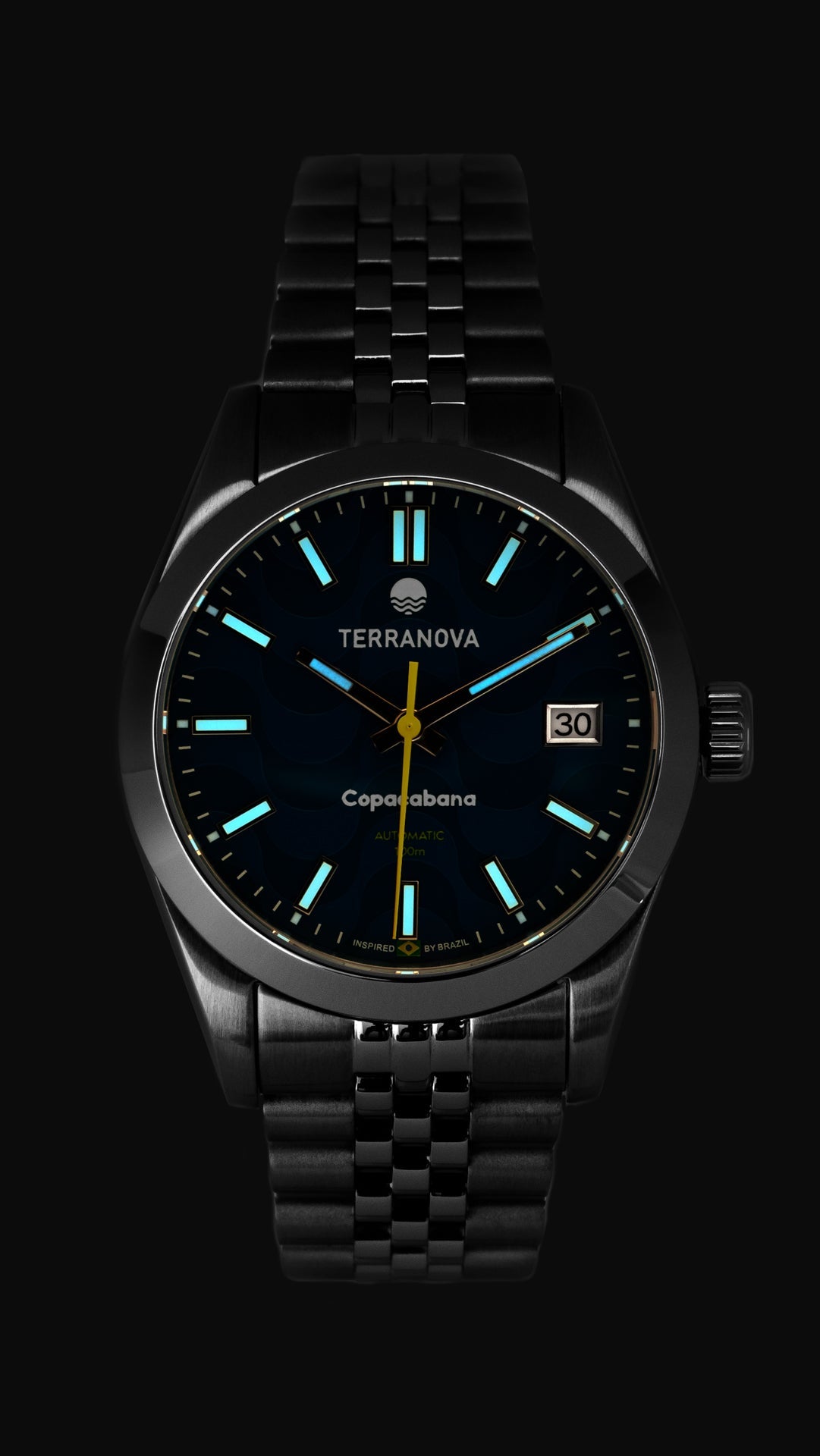 Blue dial watch glowing in low light